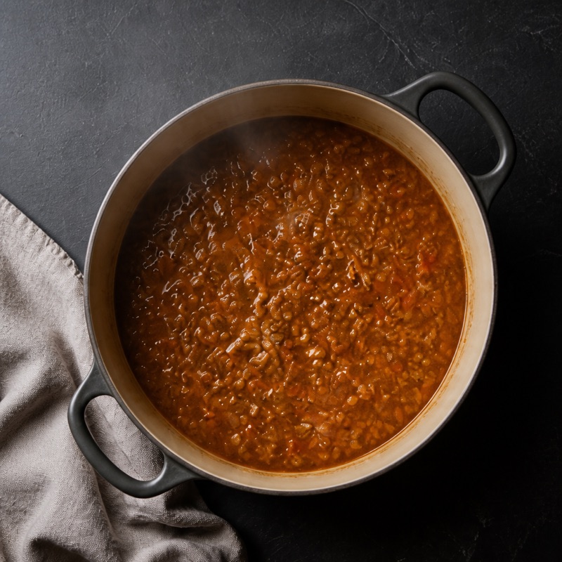 Step 2: Add lentils, tomatoes, bouillon and 400 ml water.